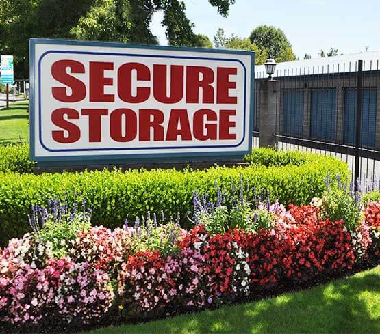 The Secure Storage sign surrounded flowers in bloom.