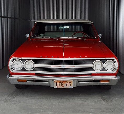 a classic red car in a storage unit