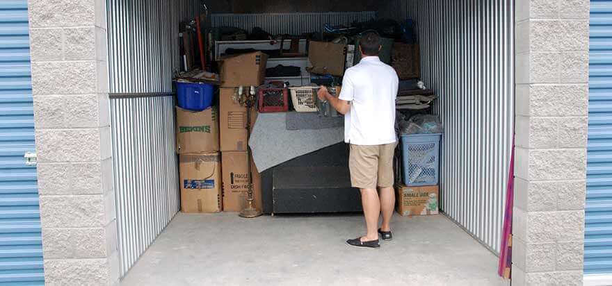 A man standing inside a storage unit
